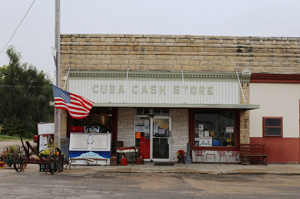 A storefront on a rural Kansas main street says "Cuba Cash Store."