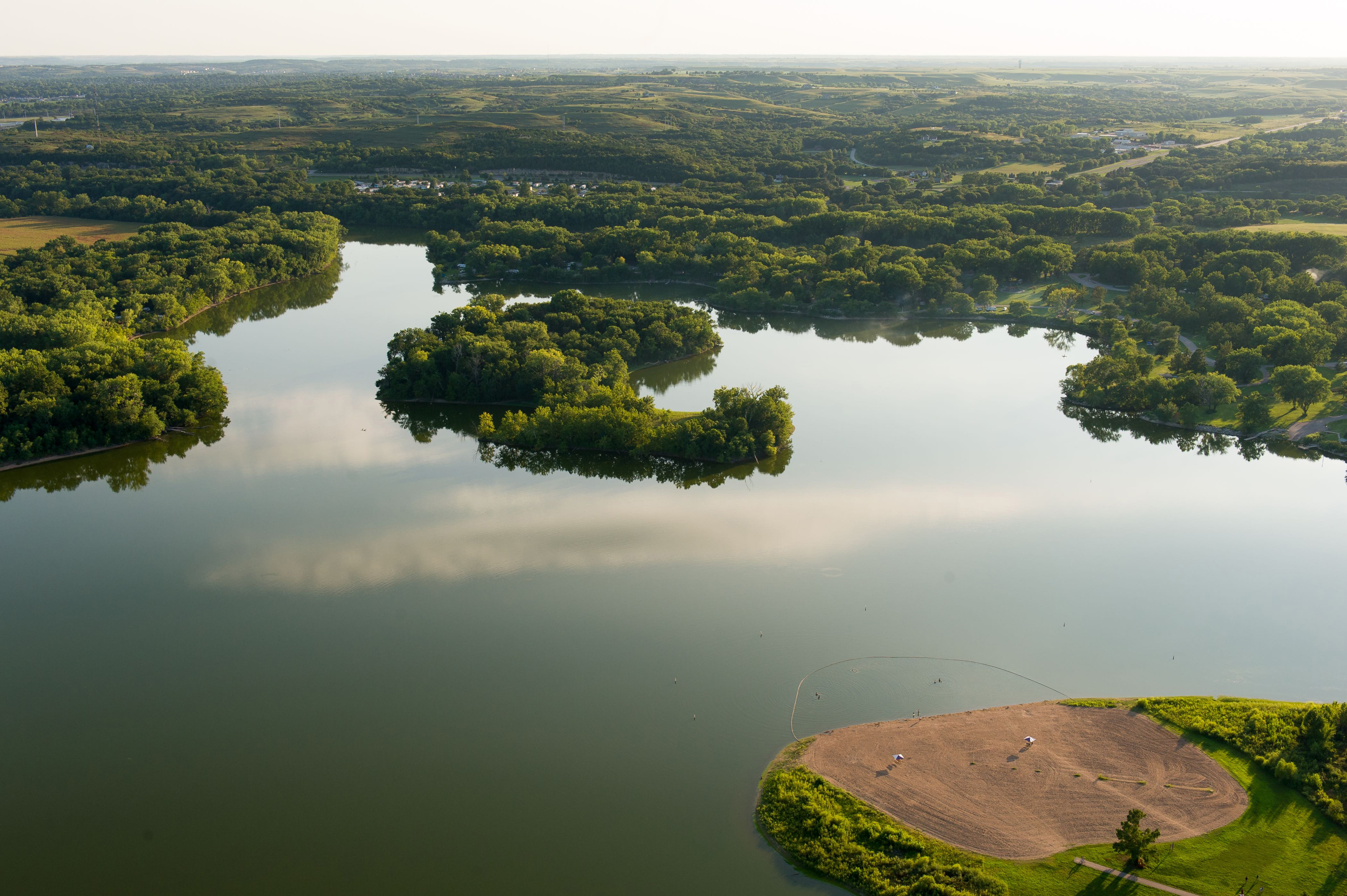A body of water with greenery around it