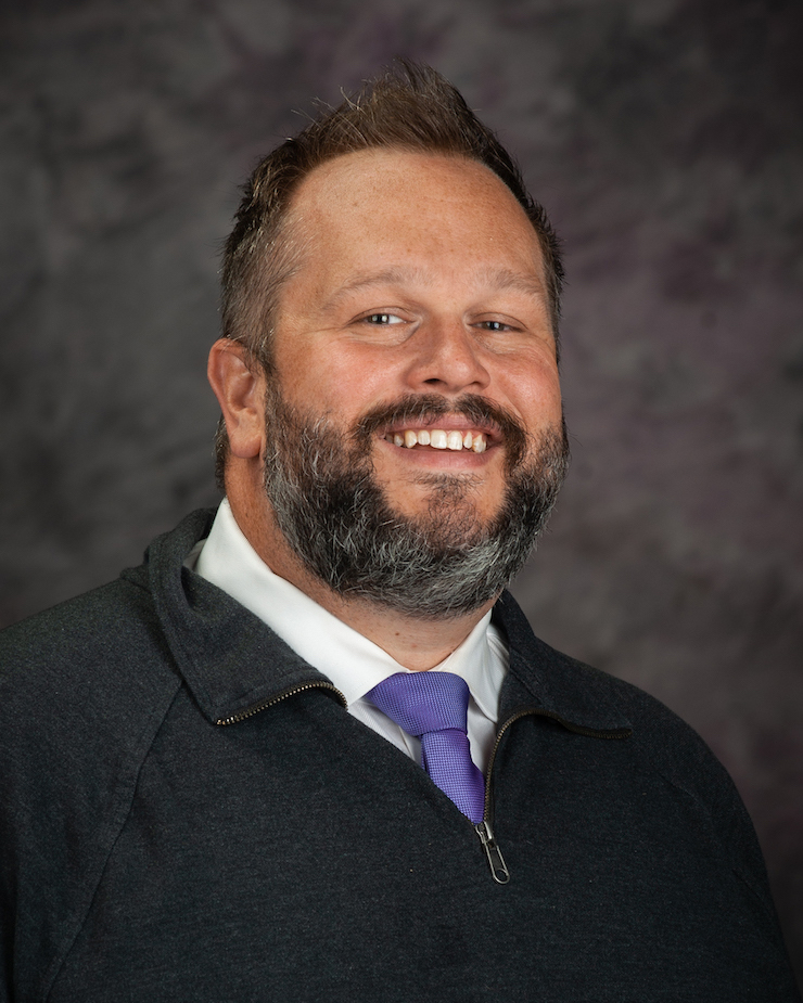 Christopher Beggs smiles for a portrait.