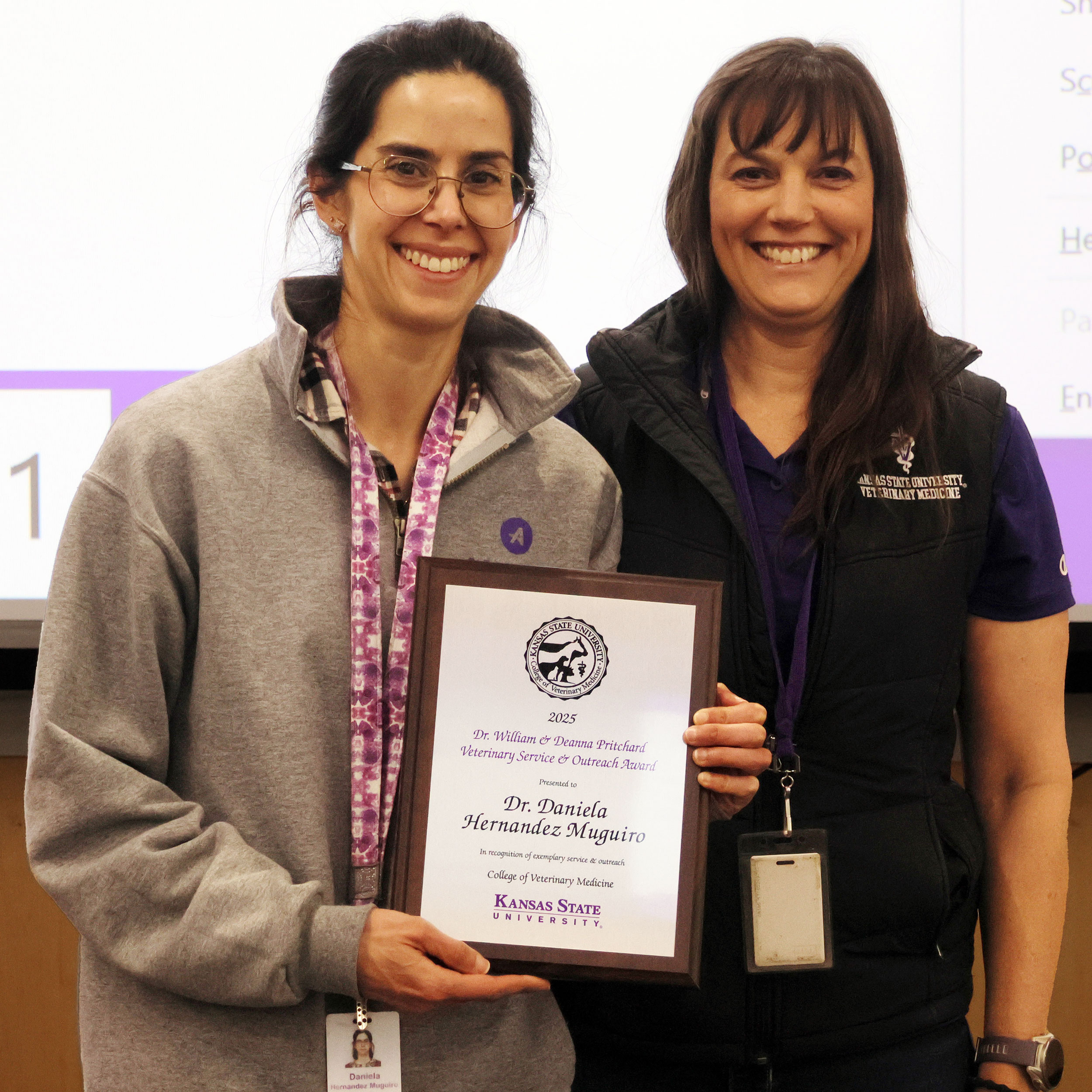 Two women stand together for a photo after the woman on the right was presented an award.