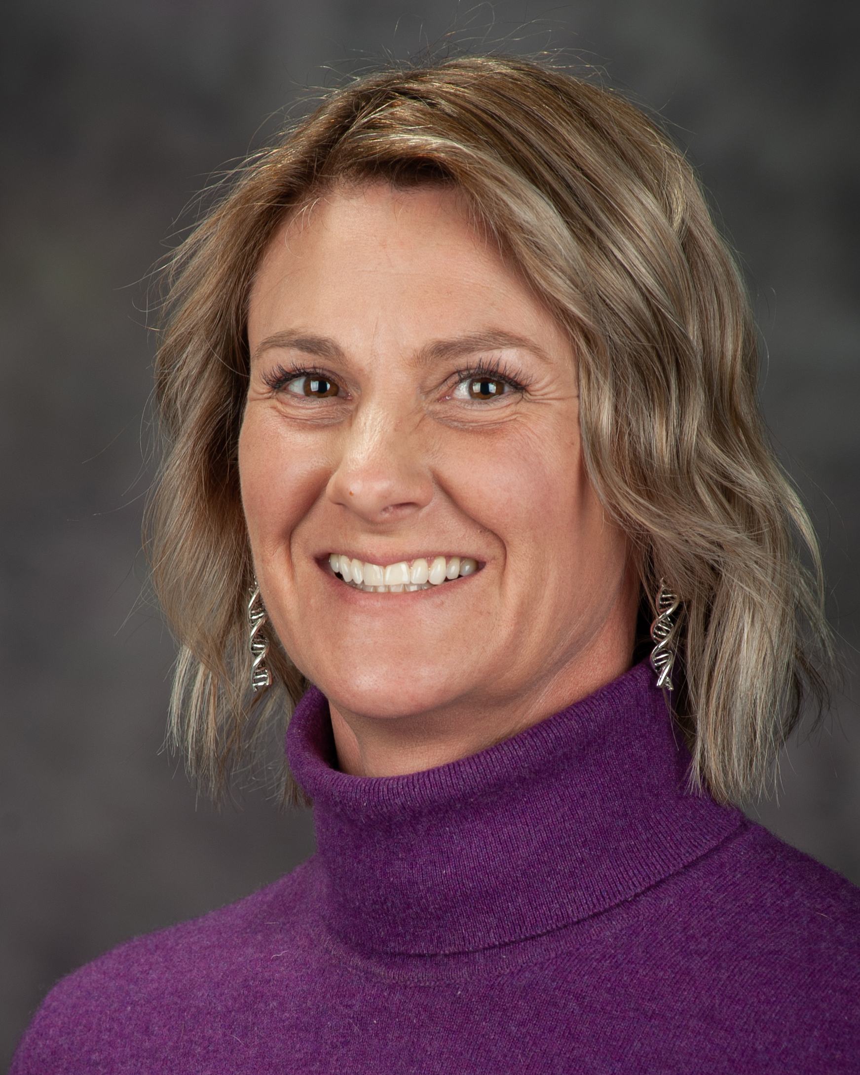 Laura Miller smiles for a portrait.