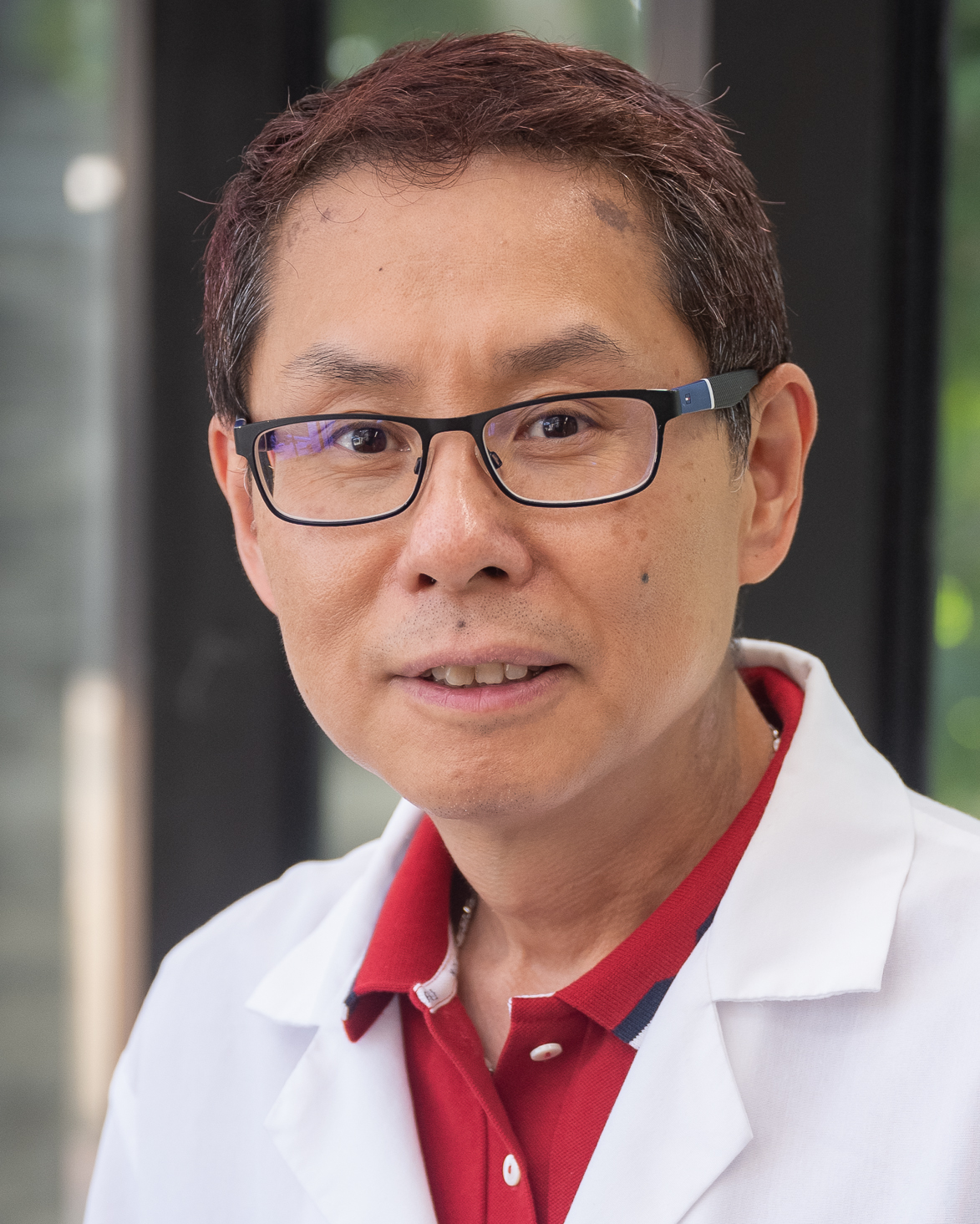 Ping Li smiles for a portrait.