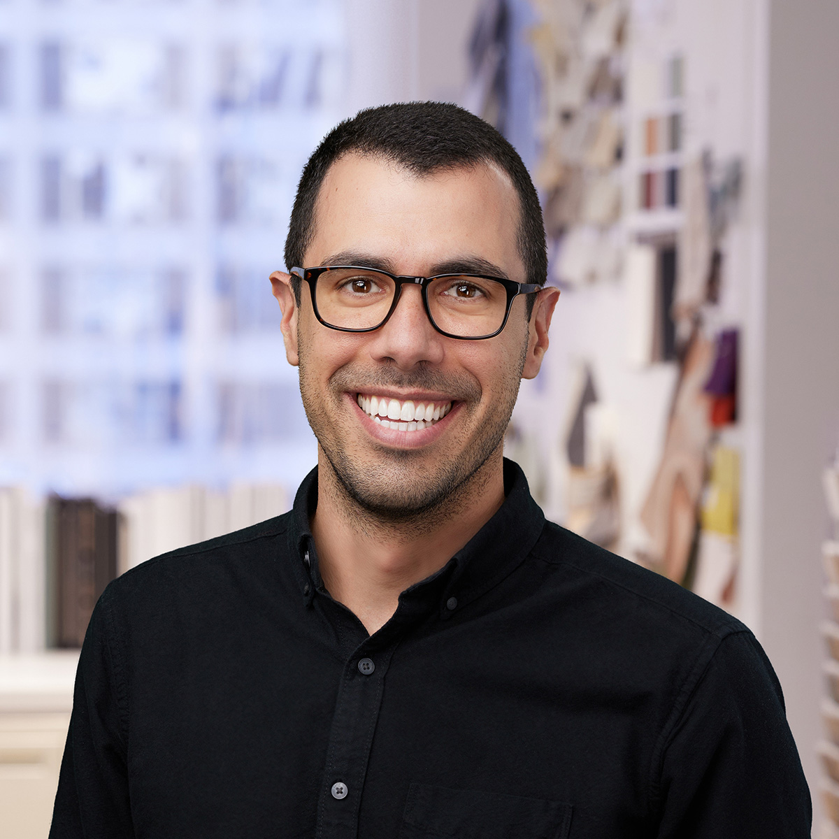 A man in glasses smiling