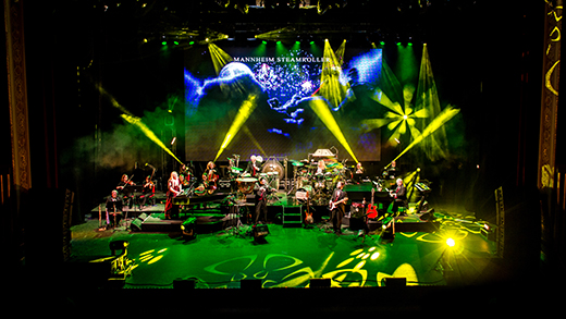 Mannheim Steamroller A stage with bright, colorful spotlights