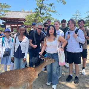 students posed together with deer in Nara, Japan