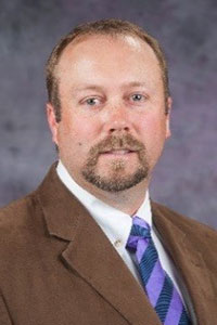 Brian Lubbers smiles for a portrait.