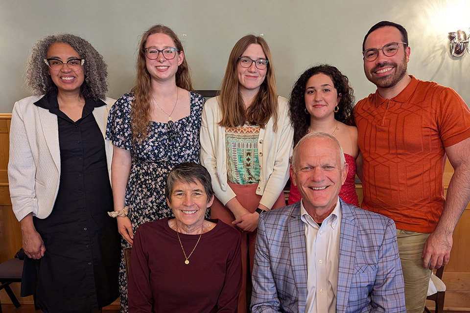 Seven people gather for a group photo. 