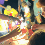 kids looking at bugs at night
