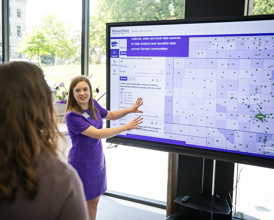 Jennifer Tidball presents an interactive map to a woman on a large portable screen.