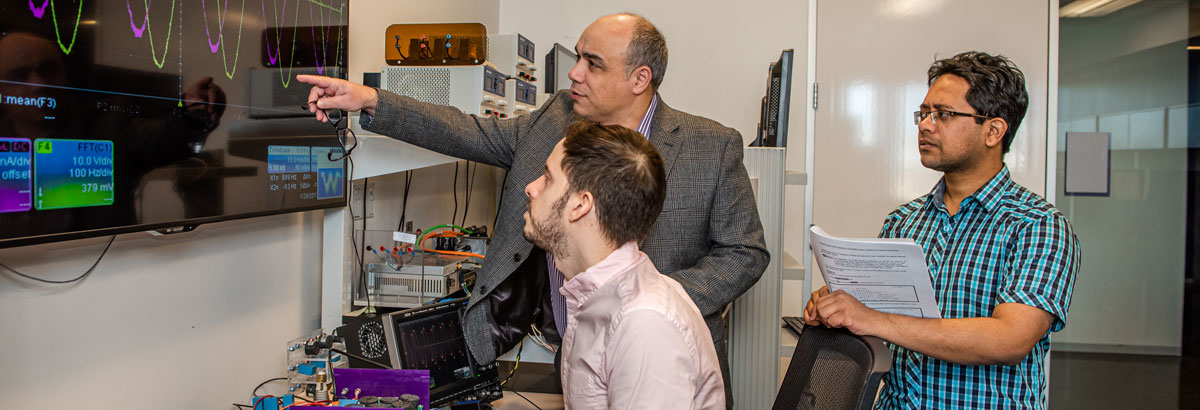 Behrooz Mirafzal and research team Engineers look at signal data.