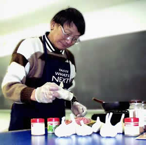 Daniel Y.C. Fung putting garlic on food