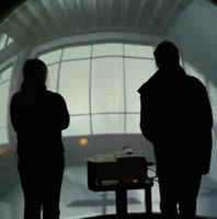 Two people stand and watch the VisionDome movie