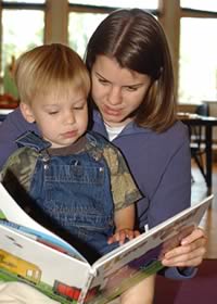 boy reading with teacher