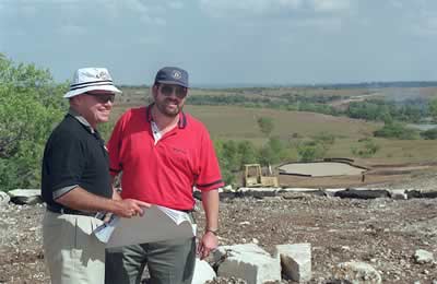 Colbert and Brauer looking at layout plans of golf course