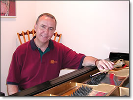 Charles Faulk at piano with tuner