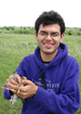 Jorge Mendoza holding a bird on the Konza Prairie
