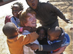 College student surrounded by children