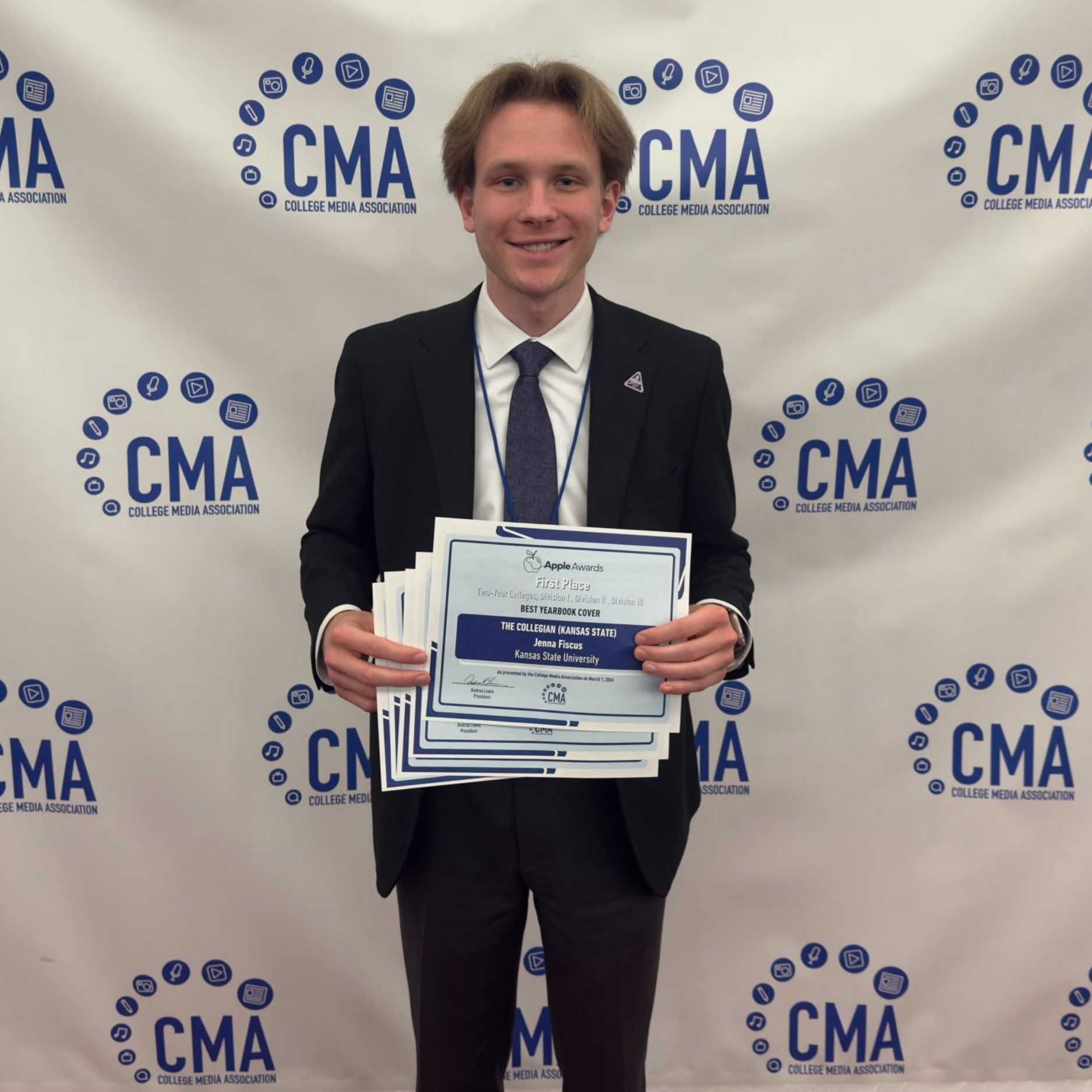 Declan Phipps holding awards at the CMA conference