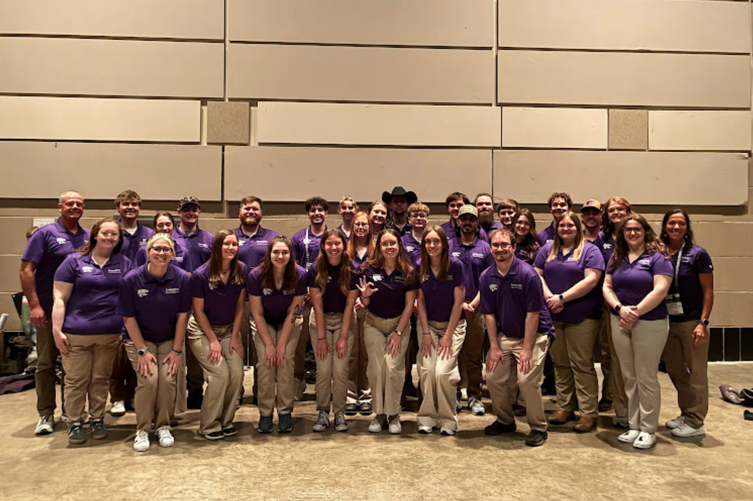 Students at NCLC pose together in purple polos