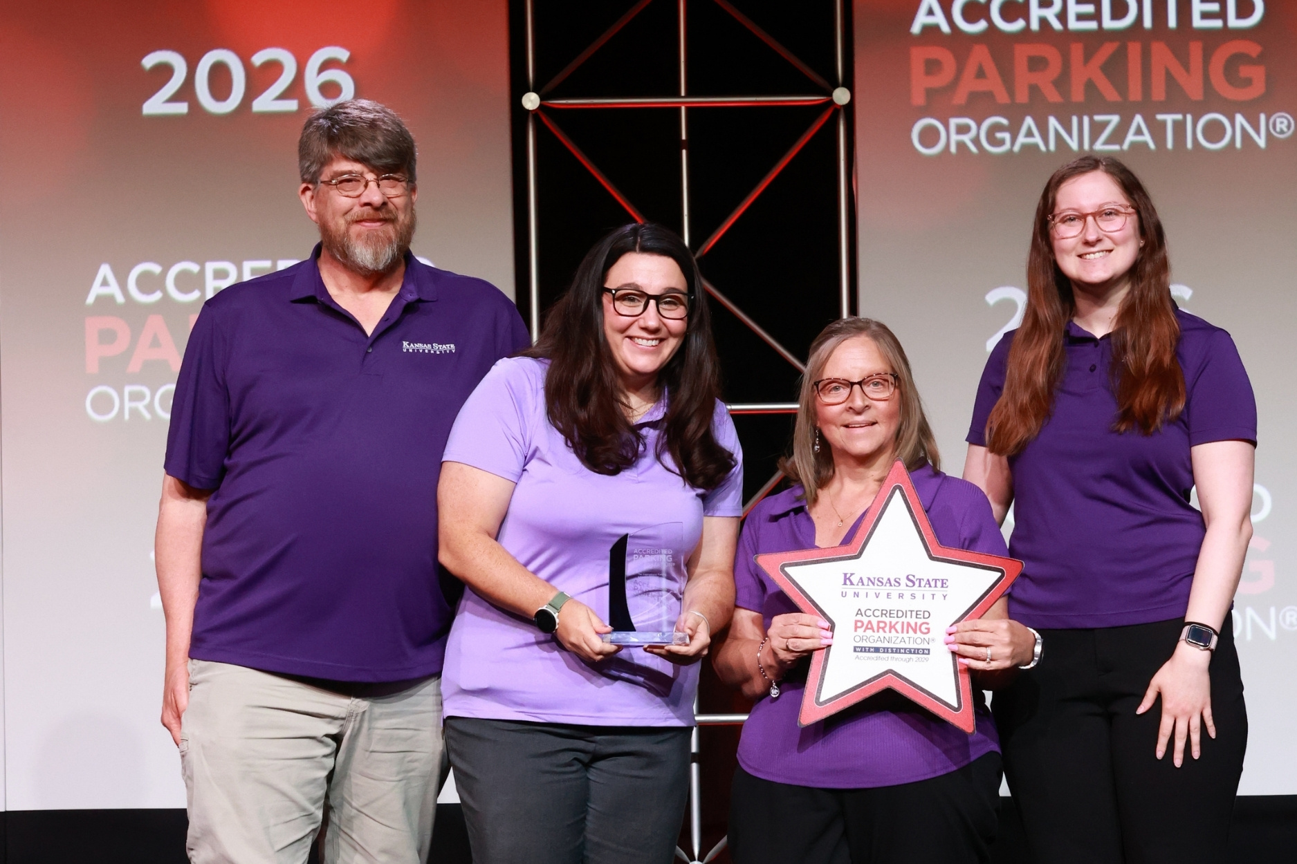 Members of K-State Parking post on stage with their award