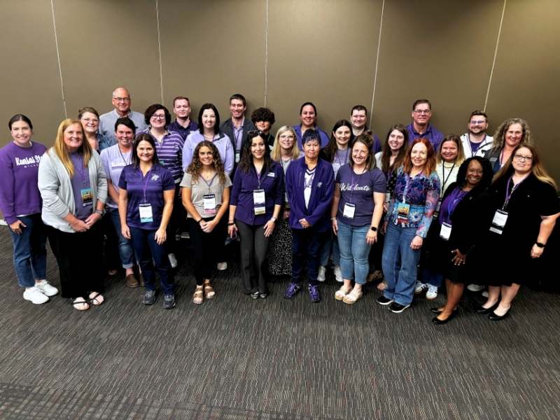 A large group of K-State academic advisors pose together for a photo at KAAN's annual conference