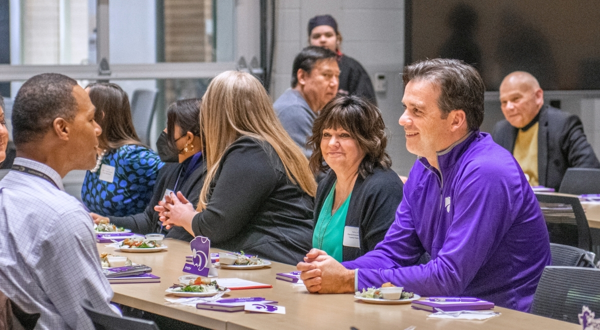 People around a table deep in discussion
