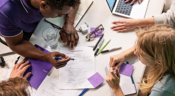 A group of people working at a table.