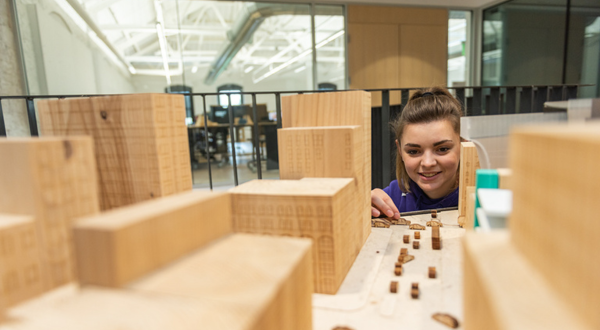 A student looks at a city model.