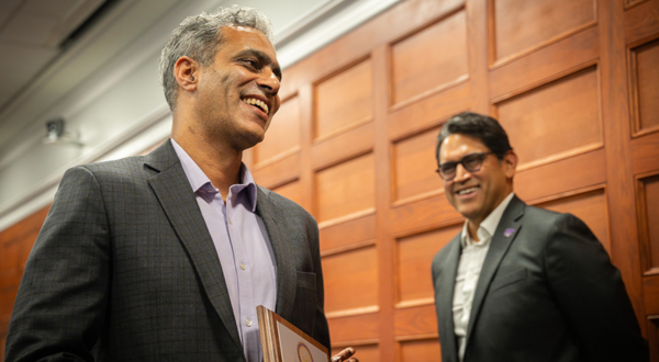 Provost Mendez smiles at a faculty member as they receive the University Outstanding Scholar award.