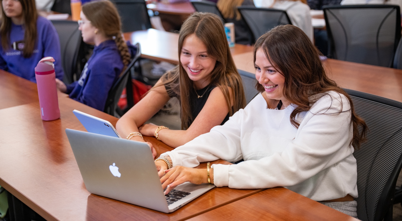 Two female students looking at a computer screen