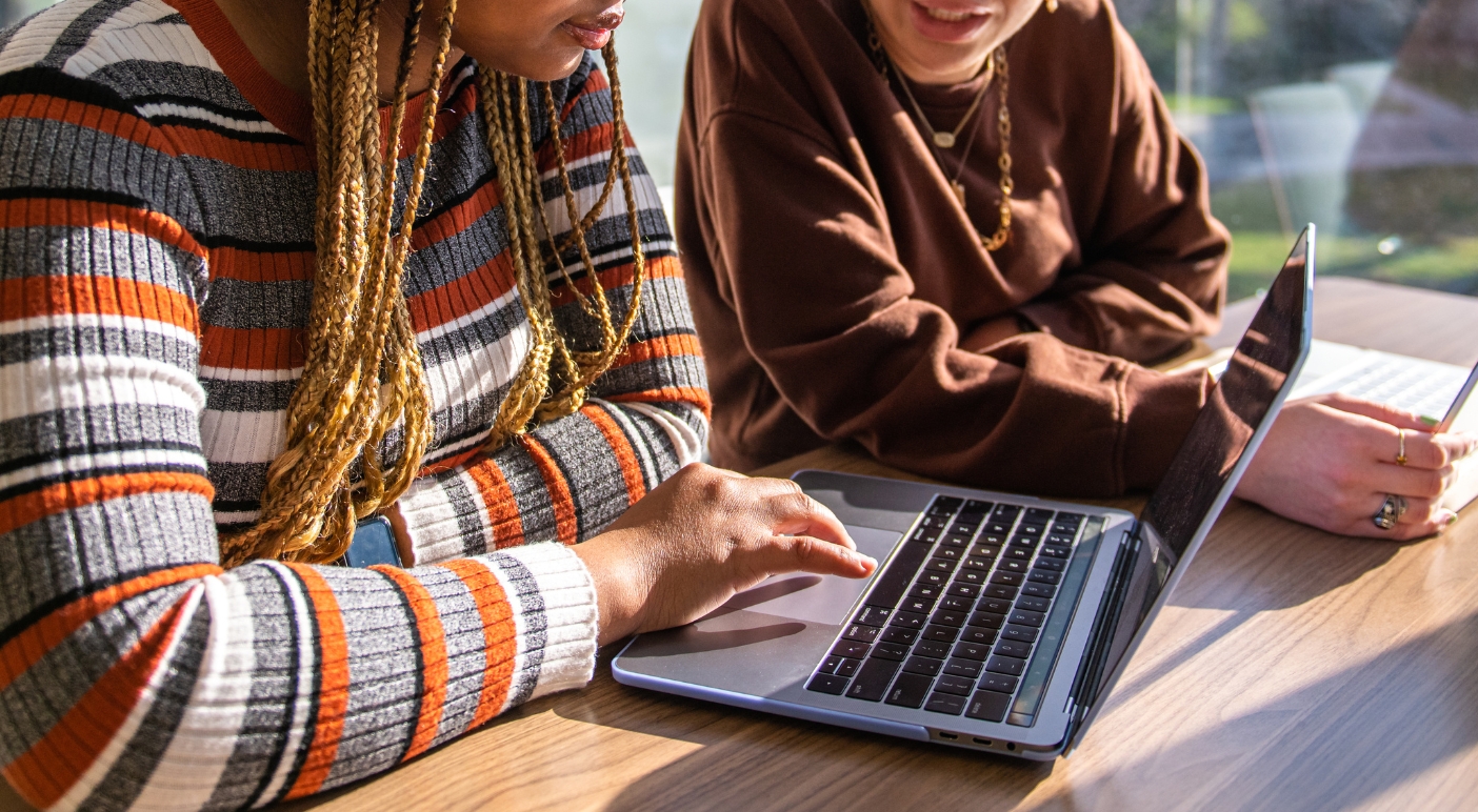 Two female students looking at a computer screen
