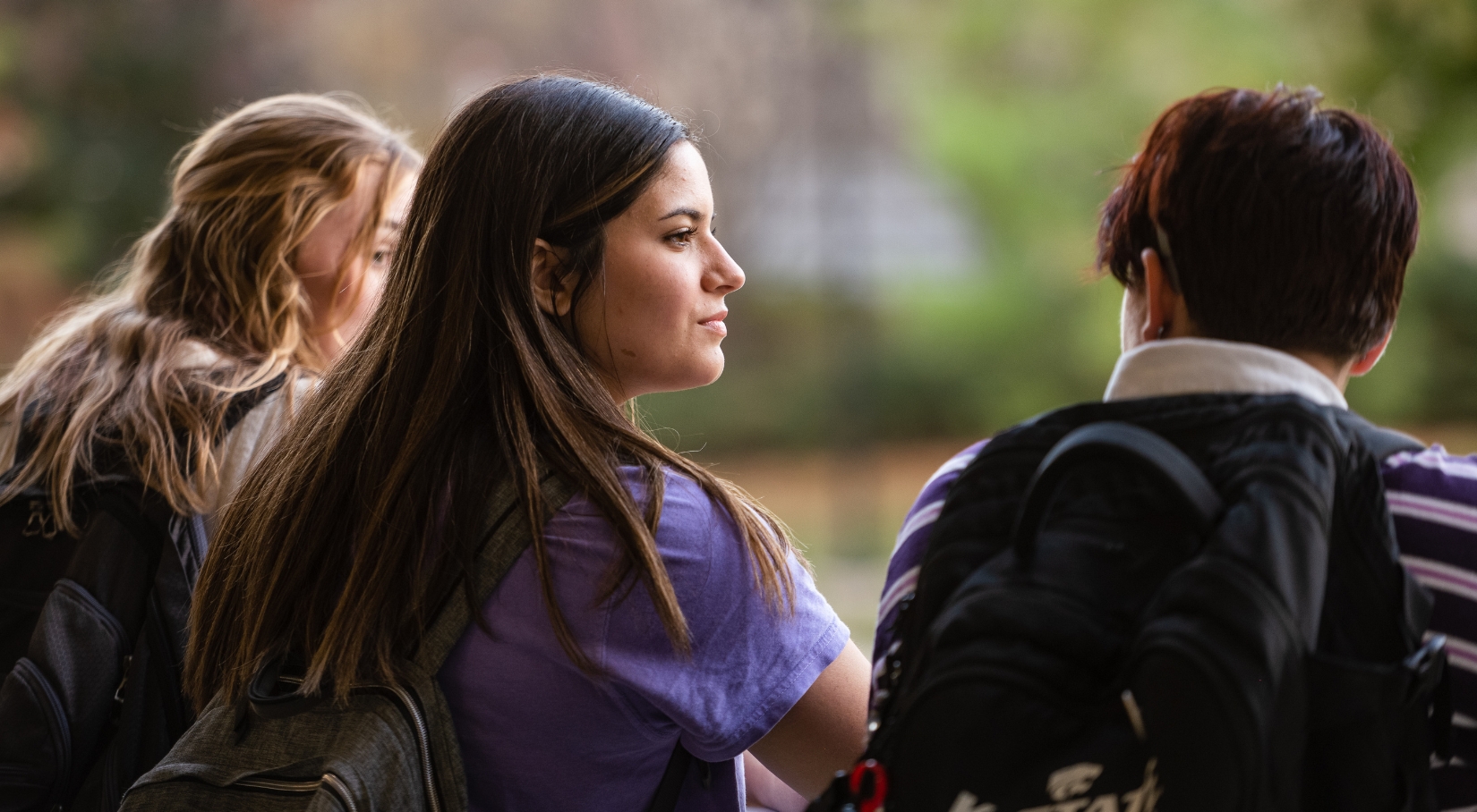 Female student looks to her right at a fellow male student