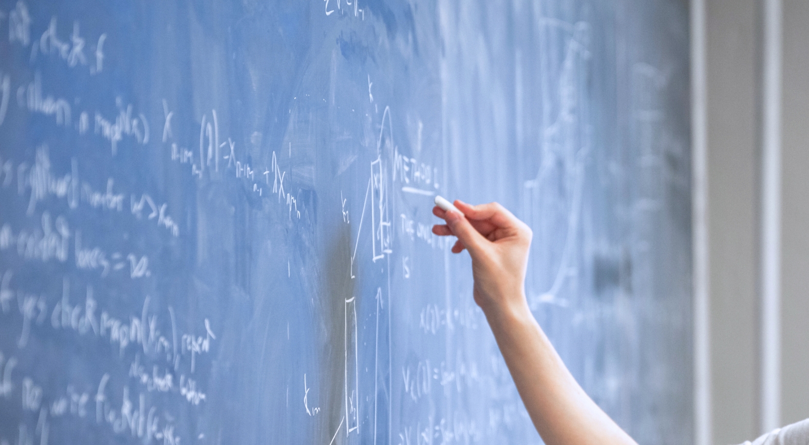 Hand writing on a chalkboard