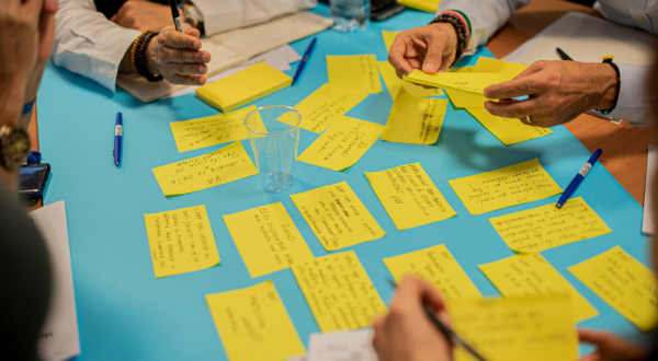 People sorting through responses written on note cards