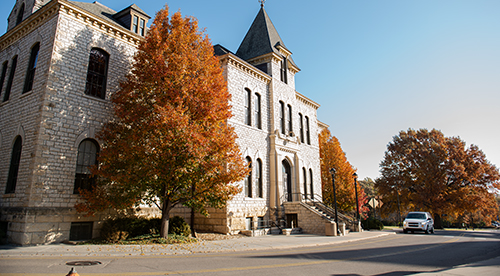 Car driving past Anderson Hall