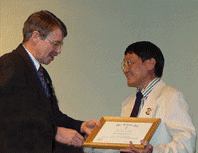 Dr. Donnelly congratulates Dr. Fung