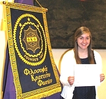 Erin Stout with banner