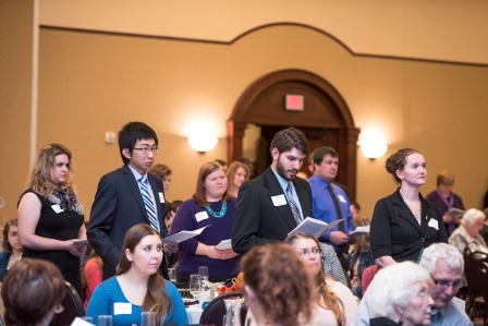 Candid photos of initiates taking the oath