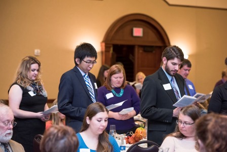 Candid photos of initiates taking the oath