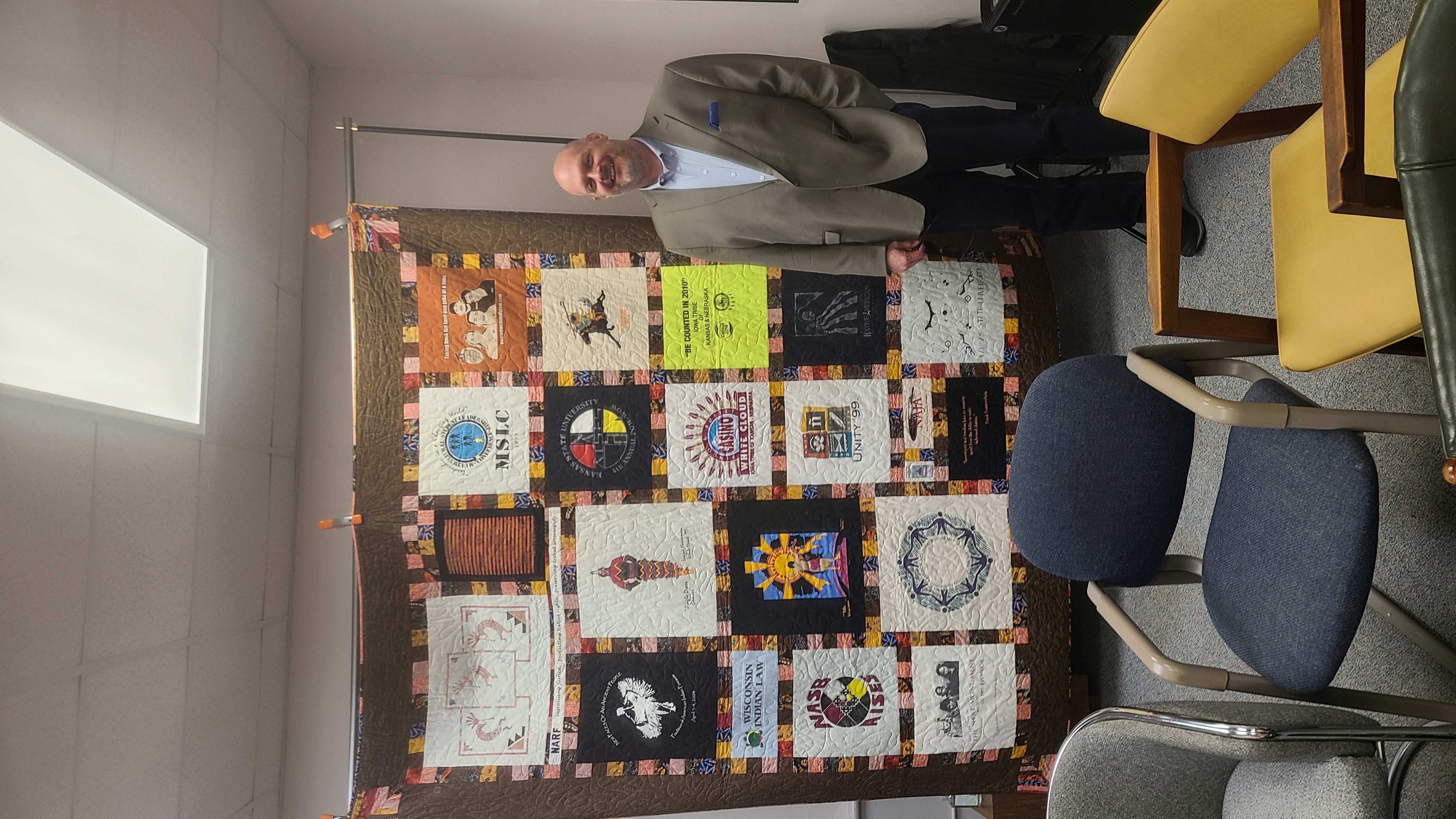 Dan Lewerenz of the Iowa Tribe of Kansas with quilt by Debby Ebke