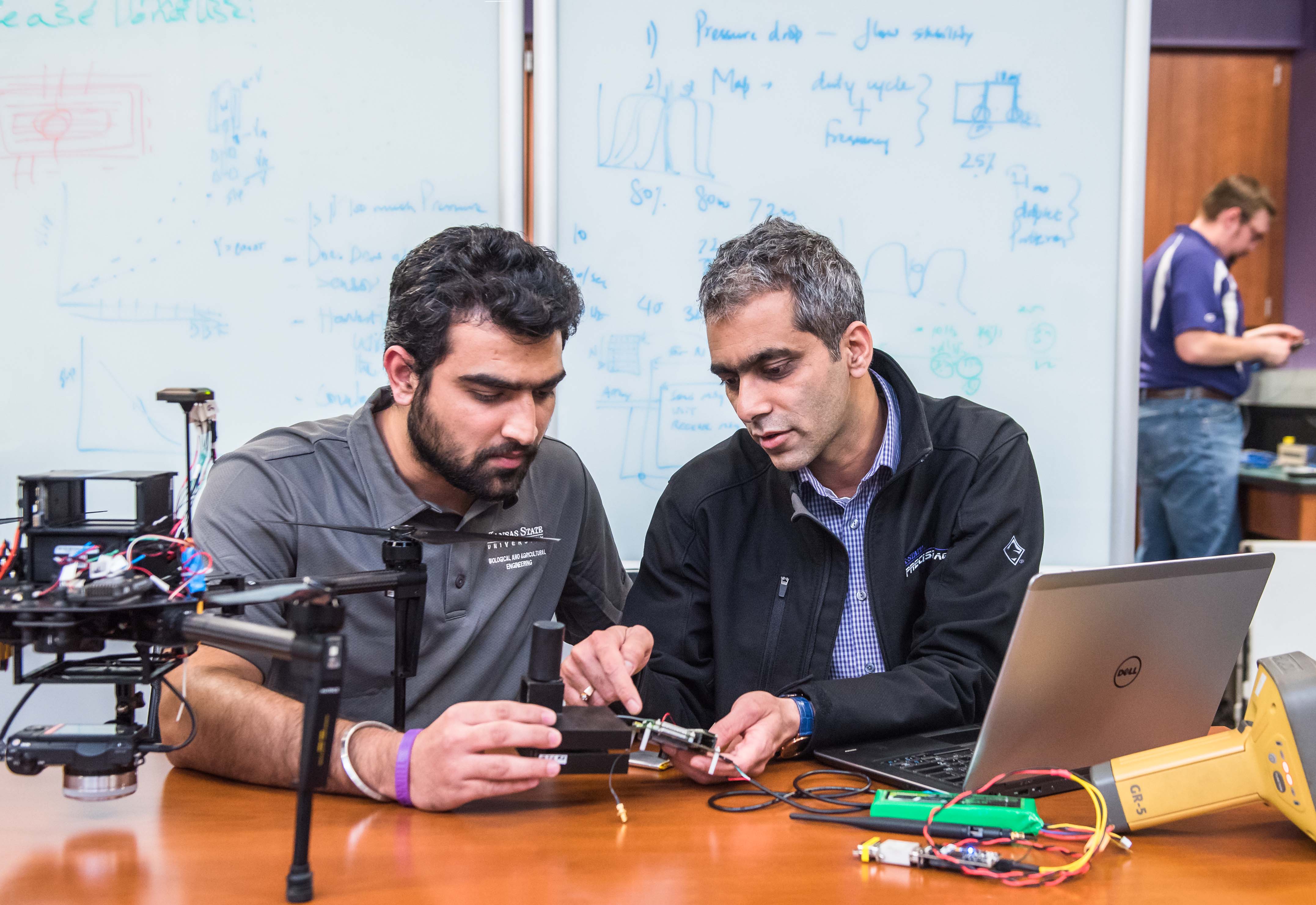 Ajay Sharda working with a student on a drone