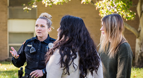 Officer assisting students