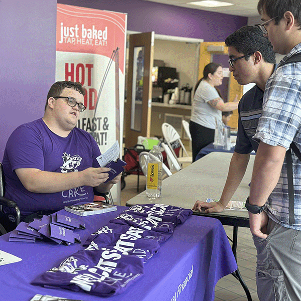 Financial Well-Being Ambassador Kaden talks with students at the Salina campus about how Powercat Financial supports the financial well-being of all K-State students.