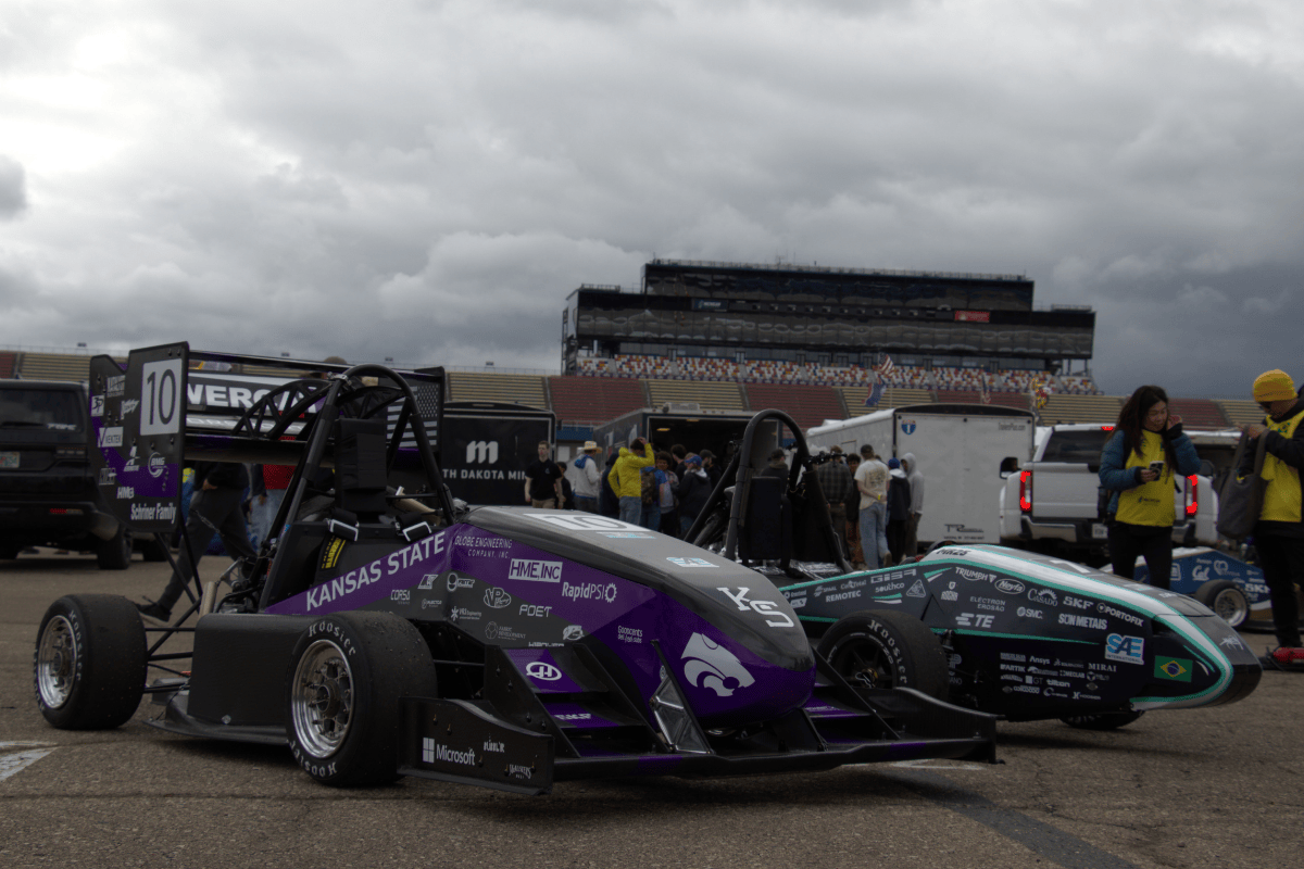 sphinx poses for a pic with the maua racing car