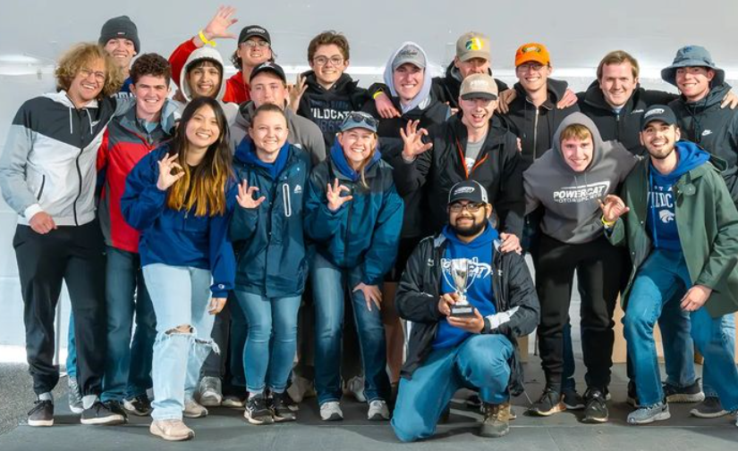 Our Michigan 2024 crew smiling with our trophy with our now former president holding our tenth place trophy.