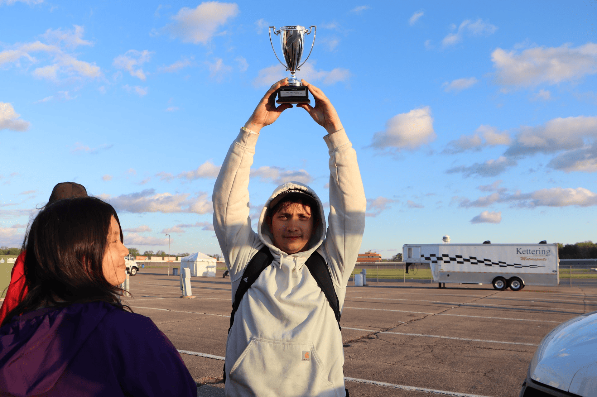 Our boy Cody holding our trophy above his head.