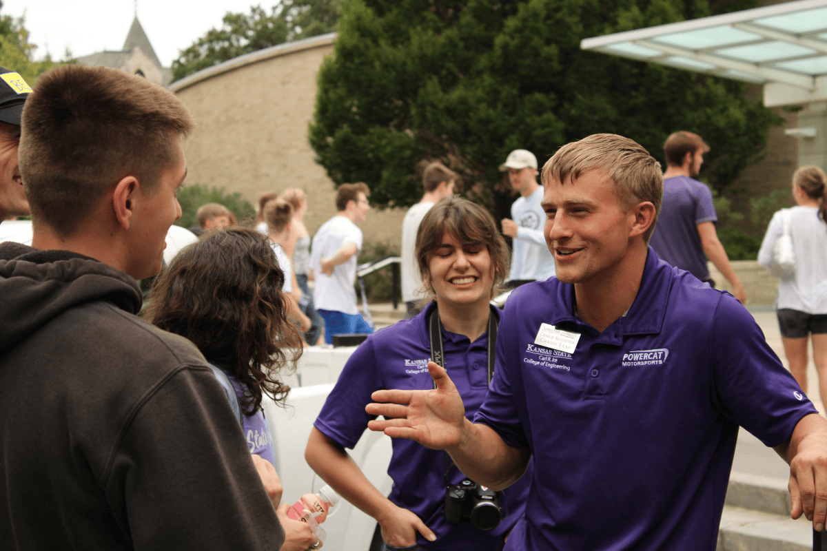Charlie the chasis lead happily talks to a prospective student