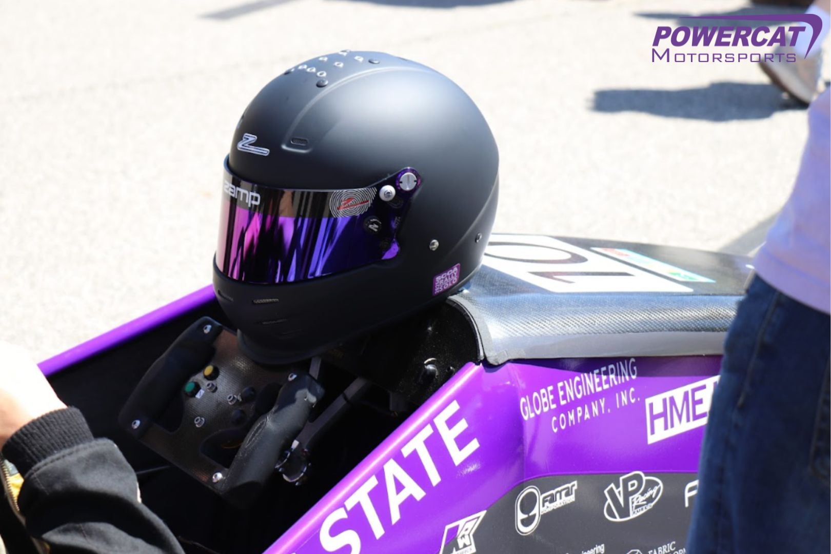 Helmet sits on the hood of the car