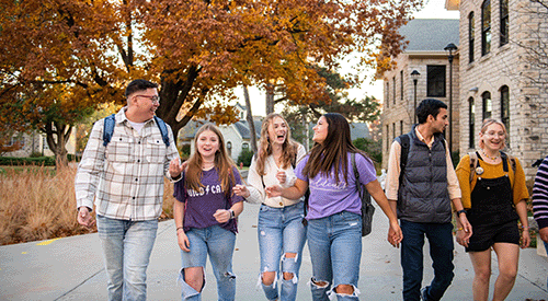 A group of students walk across Bosco Plaza on the K-State campus