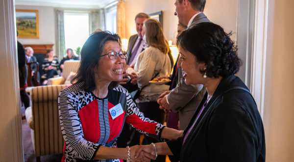 Two faculty members shake hands
